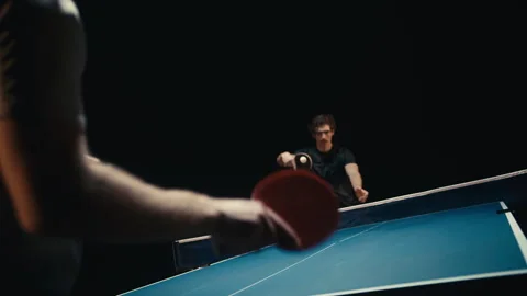 Dark room and two ping pong players in a match Stock Footage 279239793