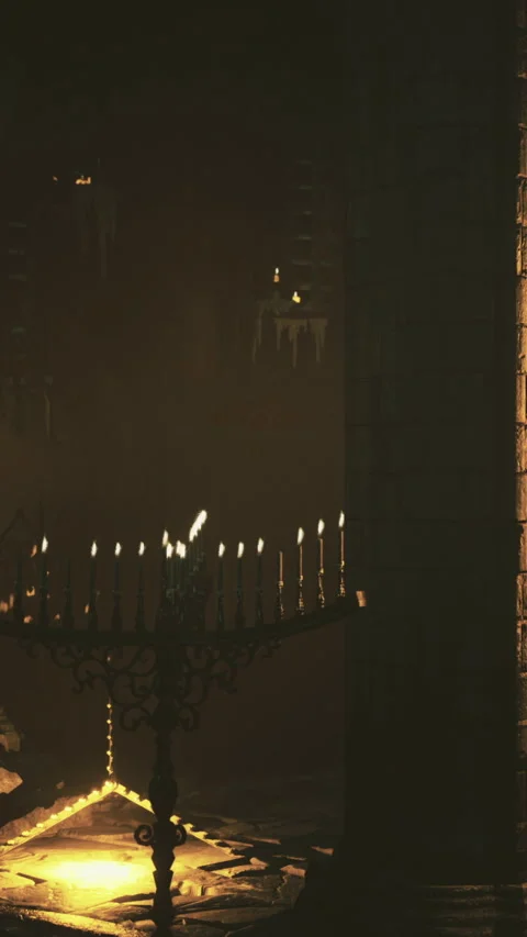 Dark room with candles and light coming from a stone wall at night Stock Footage 332220574