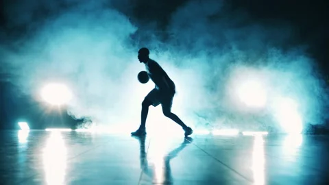 Dark room with clouds of smoke and a man throwing a basketball ball Stock Footage 149503397