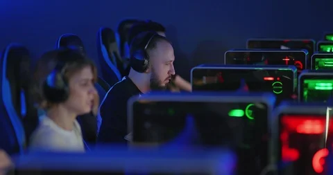 Dark room of the computer club, a team of young people playing an online game Stock-Footage 126019232