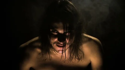 In the dark room the devil, a werewolf settles in a man. Stock Footage 81534033