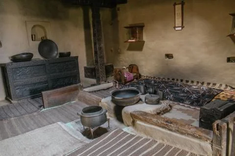 A dark room inside ancient Baltit fort display antique appliances, Pakistan. Stock Photos