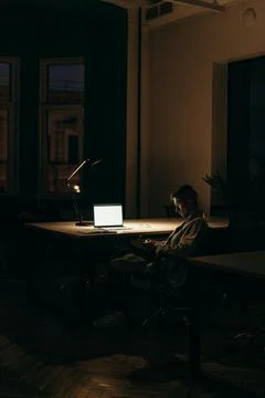 Dark room with Macbook light Stock Photos