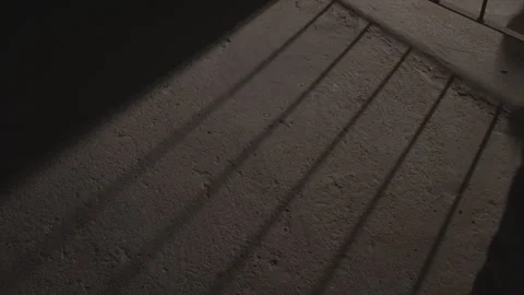 A dark room with a metal gate in the corner Stock Footage 301620524