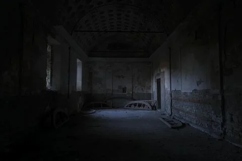 In a dark room, there is a bright light shining down from the ceiling Stock Photos