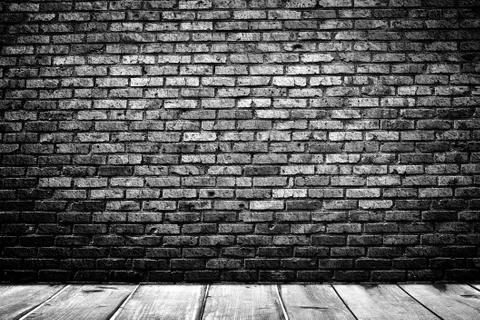 Dark room with tile floor and brick wall background Stock Photos