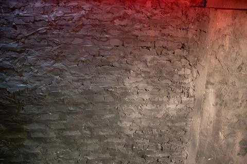 Dark rough texture on an old concrete wall and brick structure featuring unev 스톡 사진
