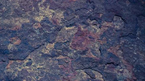 The dark rough texture of the stone with peeling rusty fragments. Vintage bac Stock Photos
