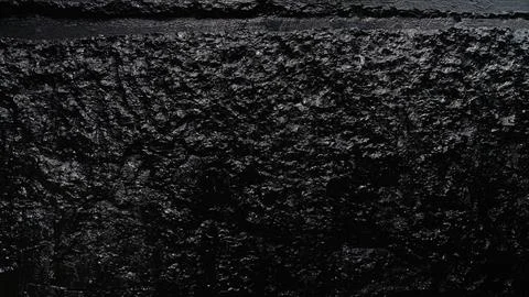 Dark rough wall surface creating abstract texture background Stock Photos