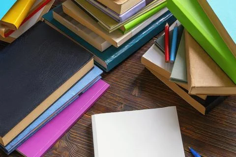 Dark rustic table with different books. Knowledge concept Stock Photos