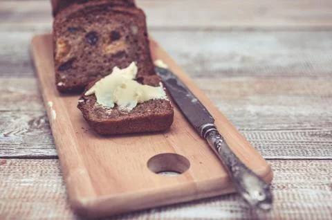 Dark rye bread with dried apricots and raisin. Healthy bread. Slices, table Stock Photos