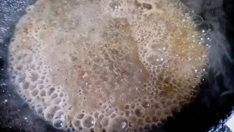 Dark Sauce Bubbling and Boiling in a Pan Stock Footage 325222796