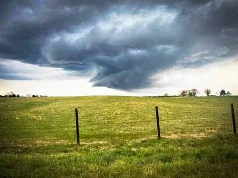 Dark Scud Clouds Over a FIeld Stock Photos