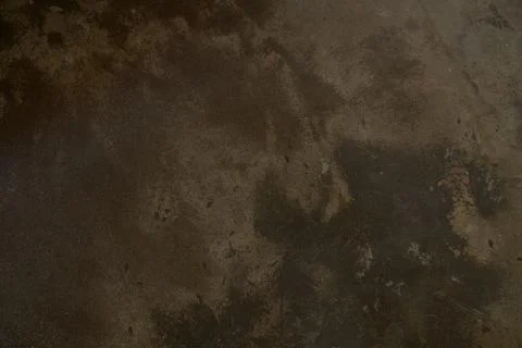 Dark scuffed surface of a stone slab. Rough texture of brown stone or rock Stock Photos
