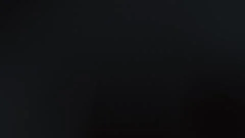 Dark seamless loop background with subtle grain. 4K textured blank. Stock Footage 309058580