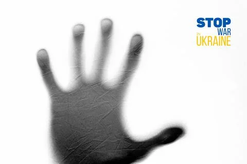 Dark shadow of an open palm on white fabric Stock-Fotos