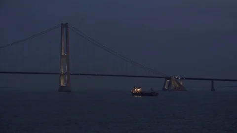 Dark ship with bright portholes sails on calm navy water Stock Footage 113093853