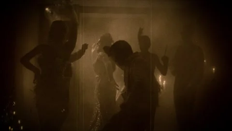 Dark silhouette group of people dancing 1920s old style sepia color film Stock Footage 330395763