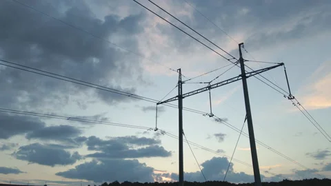 Dark silhouette of high voltage tower with electric power lines at sunset Stock Footage 163923599