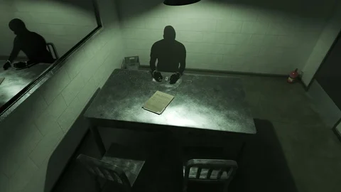 Dark silhouette of a man sitting in empty interrogation room. Stock Footage 89586479