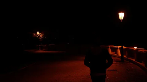 Dark Silhouette of Man Walking From Camera by Street Lantern Stock Footage 32368791