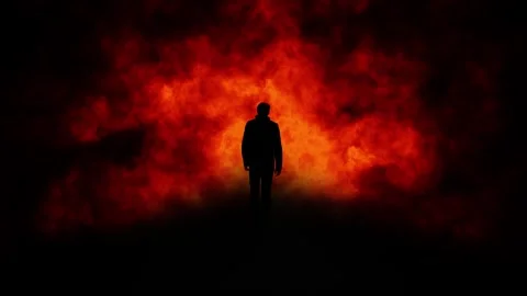 Dark silhouette of a man walking in to the fire Stock-Footage 337660888
