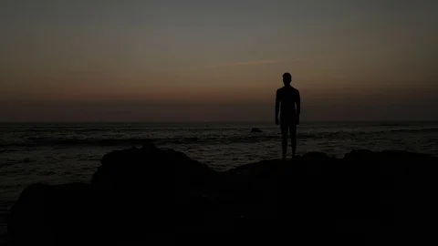 Dark Silhouette Staring at Ocean  Stock Footage 120131831