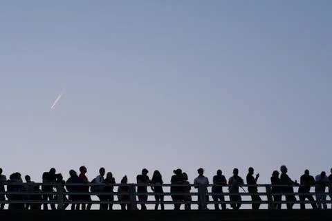 Dark silhouettes on bridge Stock Photos