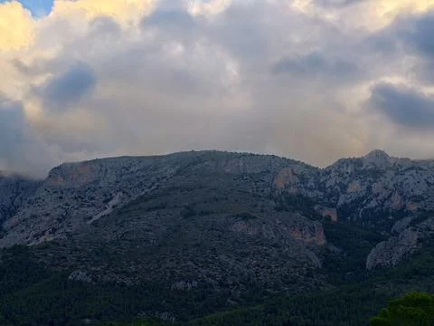Dark Skies Create Dramatic Scene, Foreboding Valley Surrounded By Turbulent Stock Photos
