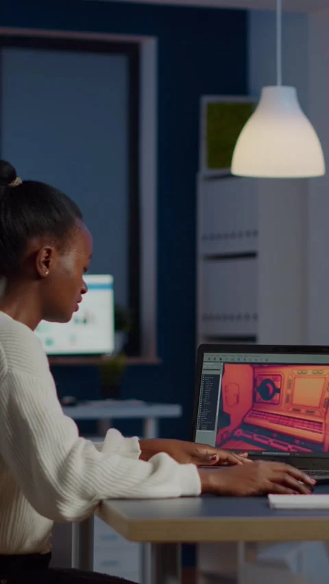 Dark skin gamer developer working at video game in midnight Stock Footage 219796840