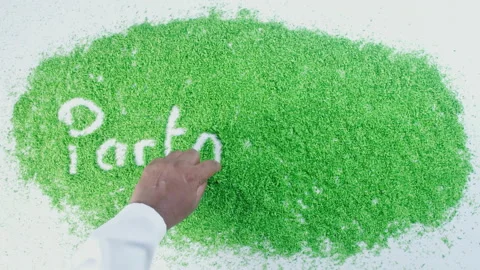 Dark skin man's hand writing in green sand words Partnership Stock Footage 248634677