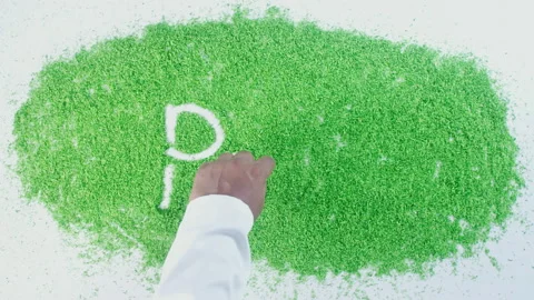 Dark skin man's hand writing in green sand words Peru Stock Footage 248639012