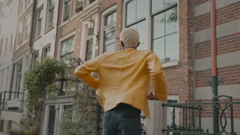 Dark Skinned Boy With White Curly Hair Walks Down Street. He Happily Walks 스톡 동영상 210211848