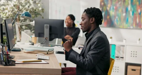 Dark-skinned co-workers sit in the company's office in front of computers 스톡 동영상 163908067