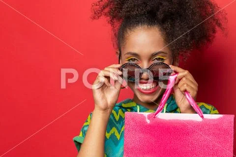 Dark-skinned girl with shopping bags Stock Photos