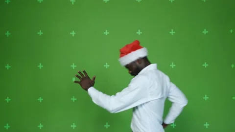 Dark-skinned guy in a Christmas hat. Stock Footage 130830729