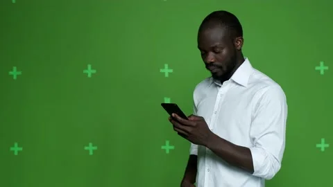 Dark-skinned guy in a white shirt talking on the phone Stock Footage 130831055