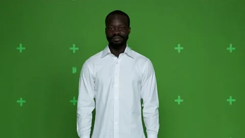 Dark-skinned guy in white shirt smiling on chrome hockey background. Close up Stock Footage 130831257