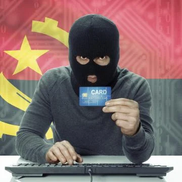 Dark-skinned hacker with flag on background holding credit card - Angola Фото
