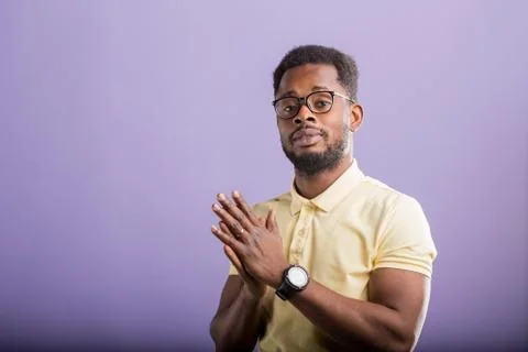 Dark skinned man isolated over purple background Stock Photos