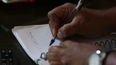 Dark-skinned man  writing notes with pan 스톡 동영상 46206997