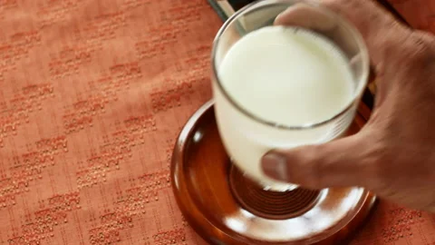 Dark-skinned man's hand picked up the milk. Stock Footage 152958681