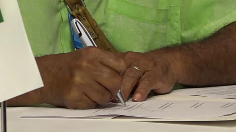 Dark-skinned man's hand writing on paper. 15.09.2024 Baku, Azerbaijan Stock Footage 283789035