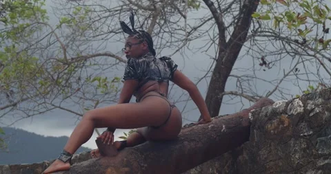 A dark-skinned model in a bunny costume walking along the walls of a Caribbean Stock Footage 335905892