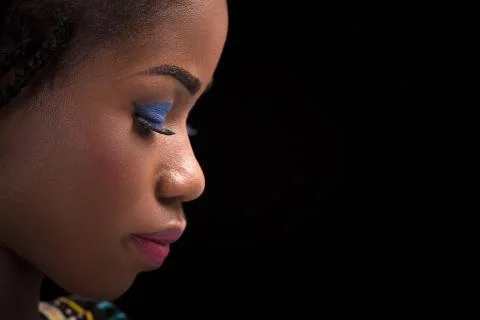 Dark skinned model posing on black background with Stock Photos