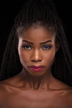 Dark skinned model posing on black background. Stock Photos