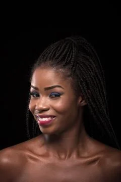 Dark skinned model smiling on black background. Stock Photos