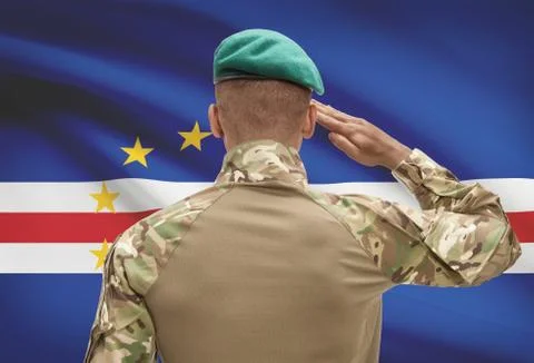 Dark-skinned soldier in hat facing national flag series - Cape Verde 스톡 사진