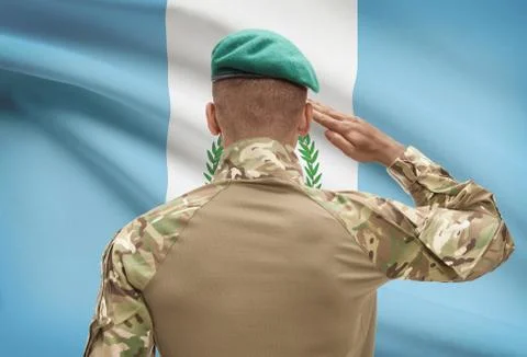 Dark-skinned soldier in hat facing national flag series - Guatemala 写真素材