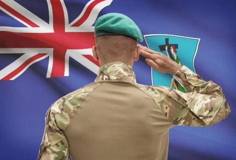 Dark-skinned soldier in hat facing national flag series - Montserrat Stock Photos
